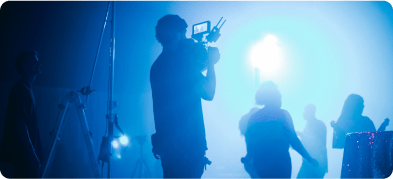 A man from the branding company is holding the camera for a shoot of an ad film.